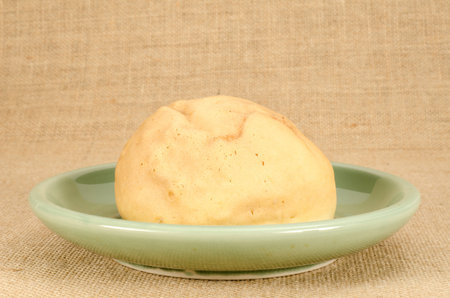 Image of cake bun in green ceramic dish