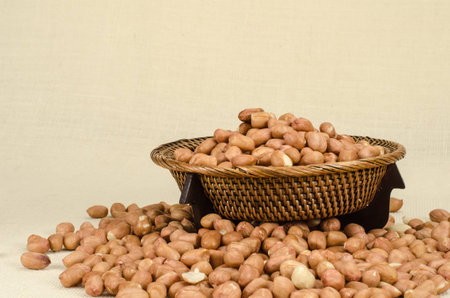 Image of raw peanuts in bamboo tray