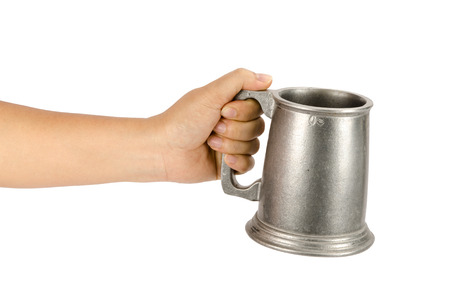 Image of old aluminum beer mug hold by hand on white backgroundの写真素材