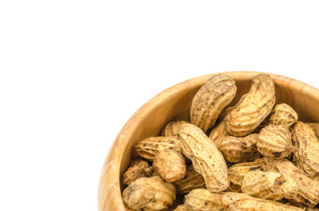 Boiled peanuts in wooden bowl on white background