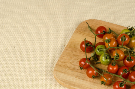 Cherry tomatoes on brownish sack backgroundの写真素材