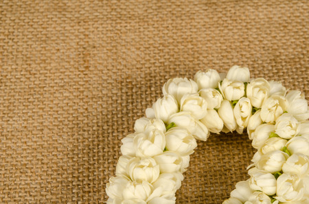 Thai jasmine garland on brown sack backgroundの写真素材