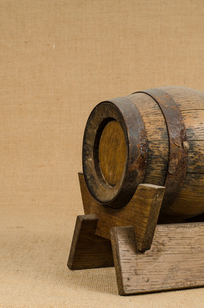 Old wooden barrel on brown sack backgroundの写真素材