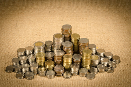 Stack of Thai baht coin on brown sack background