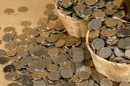 Stack of Thai baht coin on brown sack backgroundの写真素材