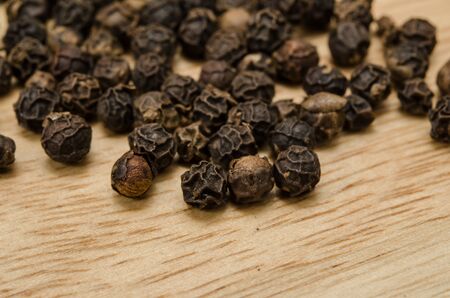 Close up image of Black pepper on wooden cutting boardの写真素材