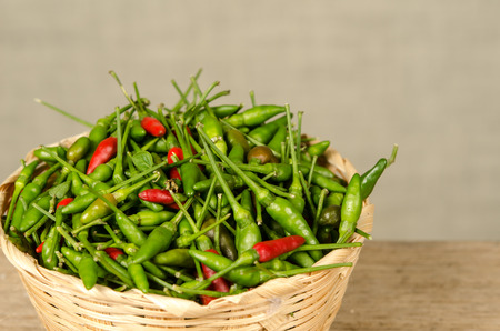 Green and red Thai chili peppersの写真素材