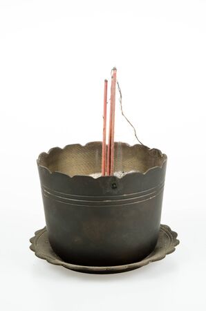 Ancient brass incense burner, joss stick pot on white backgroundの写真素材