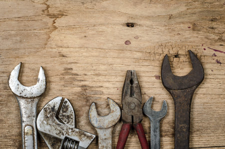 Old rusty wrench on old wood