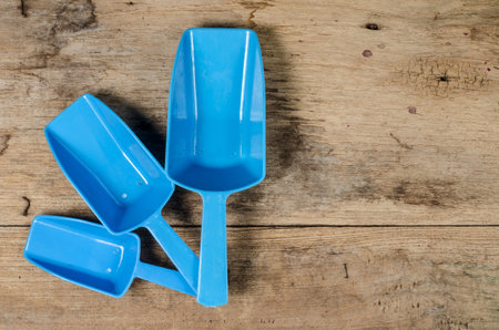 Blue plastic spoon on old wood desk