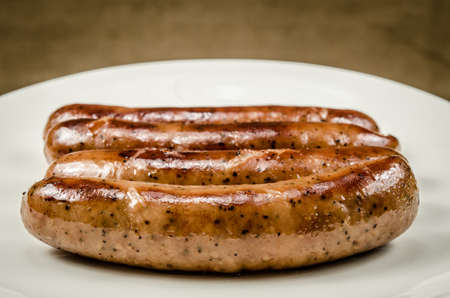 Roasted Sausages on white dishの写真素材