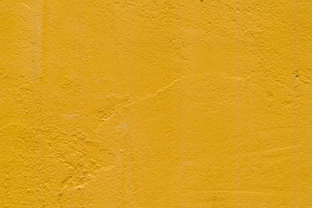 Yellow concrete wall background textureの写真素材