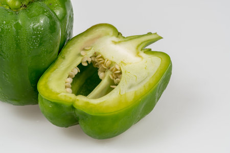 Sliced green bell peppers on white background
