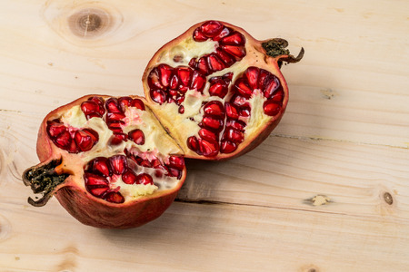 Pomegranate on wooden deskの写真素材