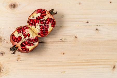 Pomegranate on wooden deskの写真素材