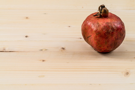 Pomegranate on wooden deskの写真素材