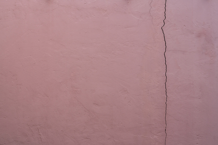 Old brown crack concrete wall background textureの写真素材