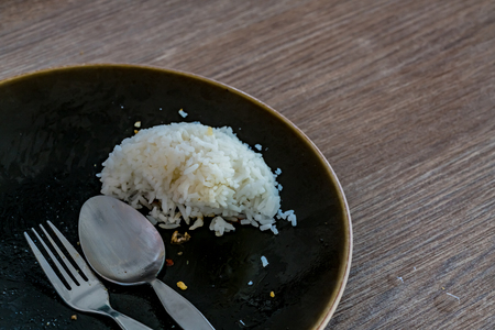 Leftover rice on black dishの写真素材