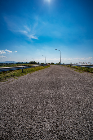 Asphalt road with green plants in the countryside of Thailandの写真素材