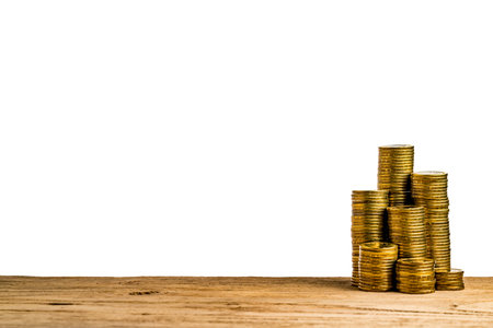 Stack of Golden coin on brown wooden board isolate on white background