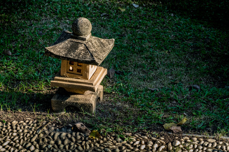 Chinese traditional stone lantern on green grassの写真素材