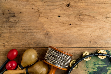Flat lay of Latin percussion on brown wood desk