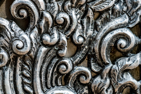 Close up image of Thai's old style pattern on silver plate