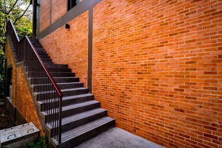Gray concrete staircase with brown brick wallの写真素材