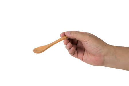 Man hand holding wooden spoon isolate on white backgroundの写真素材