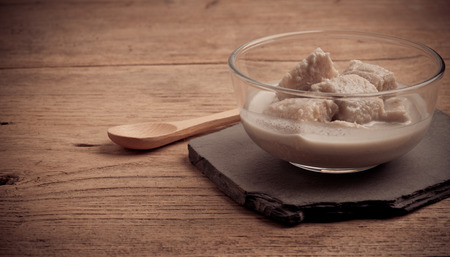 Image of banana in coconut milk, Thai dessert in glass bowl, vintage style filterの写真素材