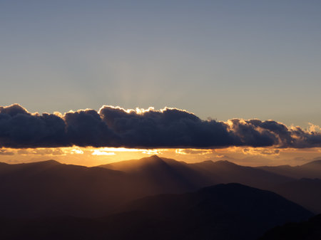 Mountain ridge at sunset with ray castingの写真素材