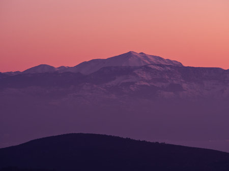 Mountain range covered in snow in dusk colors, Greeceの写真素材
