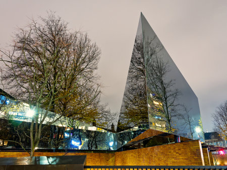 Corporate glass building facade under moody skyの写真素材
