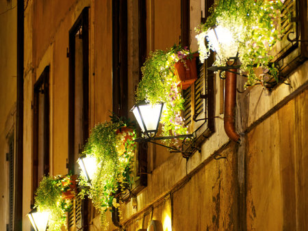 Street lights and flowers in city building. Rome, Italyの写真素材