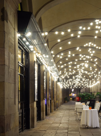 Pave-stone urban city alley with festival lightsの写真素材