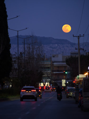 City road traffic in the view of a full moonの写真素材