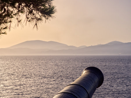 Fortified cannon and sea view at sunset in Hydra island. Saronic Gulf, Greeceの写真素材