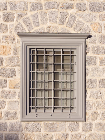 Front-view of window close-up facade in stone wallの写真素材