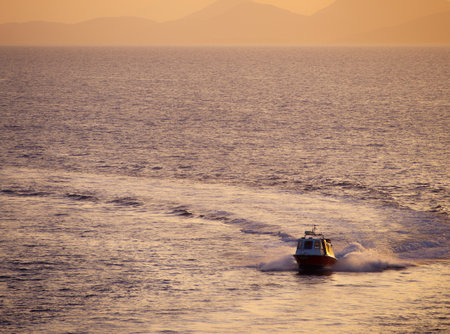 Taxi transport boat during sunset i at Hydra island. Saronic Gulf, Aegean Sea, Greeceの写真素材