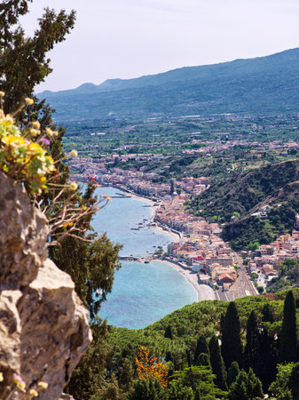 Coast of Sicily Giardini Naxos seen from Taormina theater. Mount Etna in the back on a sunny summer day.の写真素材