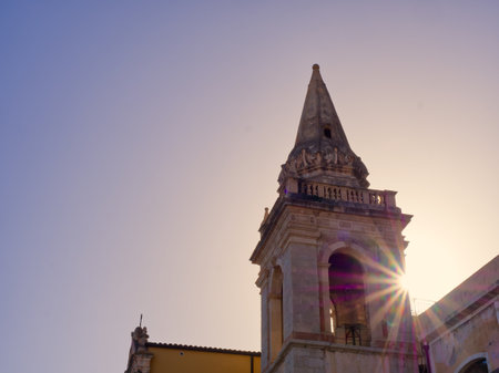 Taormina church bell tower with sun star effect, Sicily, Italyの写真素材