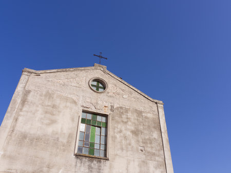 Church of Santa Domenica facade under blue sky with stained glass windows in Taormina, Sicily, Italyの写真素材