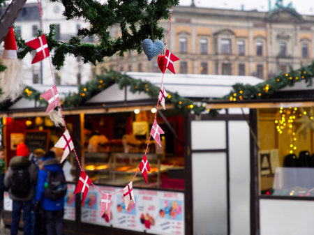 Danish small flags hanging from as ornament in a Christmas market stall in Copenhagen, Denmarkの写真素材