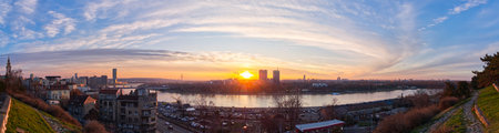 Breathtaking panoramic view of Belgrade skyline at sunset with Danube River and cloudy sky