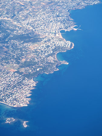 Birds-eye view of a densely populated Artemida coastal area with buildings, beaches, and blue seaの写真素材