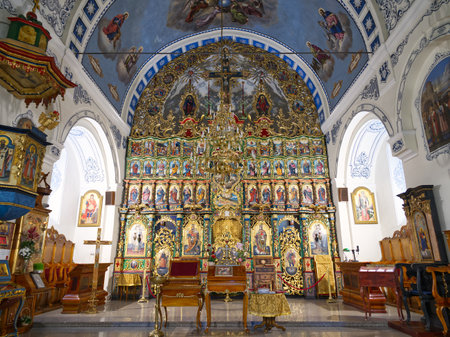Richly decorated iconostasis and altar in an Eastern Orthodox church with elaborate frescoes and arches in Zemun, Belgradeの写真素材