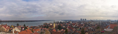 Aerial panorama of Zemun with Danube river, red rooftops, and Belgrade skyline in backgroundの写真素材