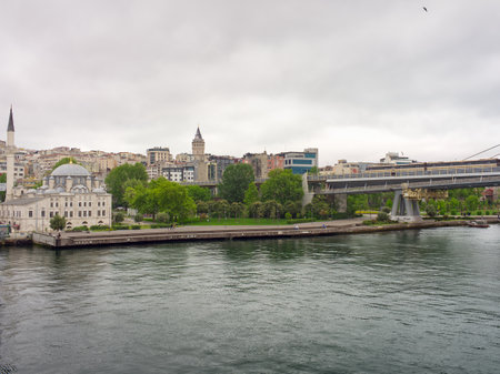 View of Istanbul's waterfront with historic buildings, modern structures, and the Bosphorus straitの写真素材