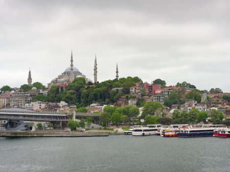 View of Istanbul's historic skyline featuring the Suleymaniye Mosque, with boats on the Bosphorus.の写真素材