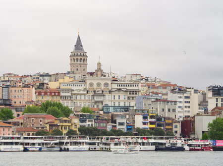 Panoramic view of Istanbul's skyline featuring the iconic Galata Tower and waterfront with boatsの写真素材